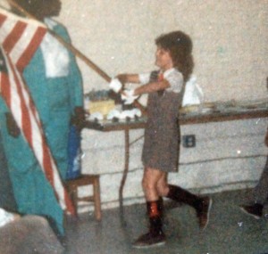 Trudy serving as a flag-bearer in her Brownie Girl Scout outfit.